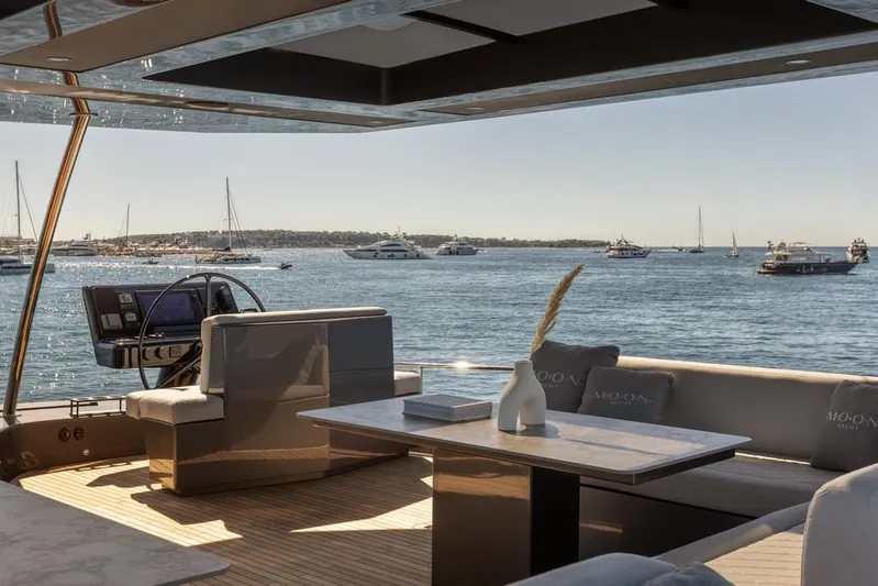 Full Moon Yacht Photos Pics Luxurious 2024 Moon 60 Sail yacht interior with ocean view and elegant seating area.