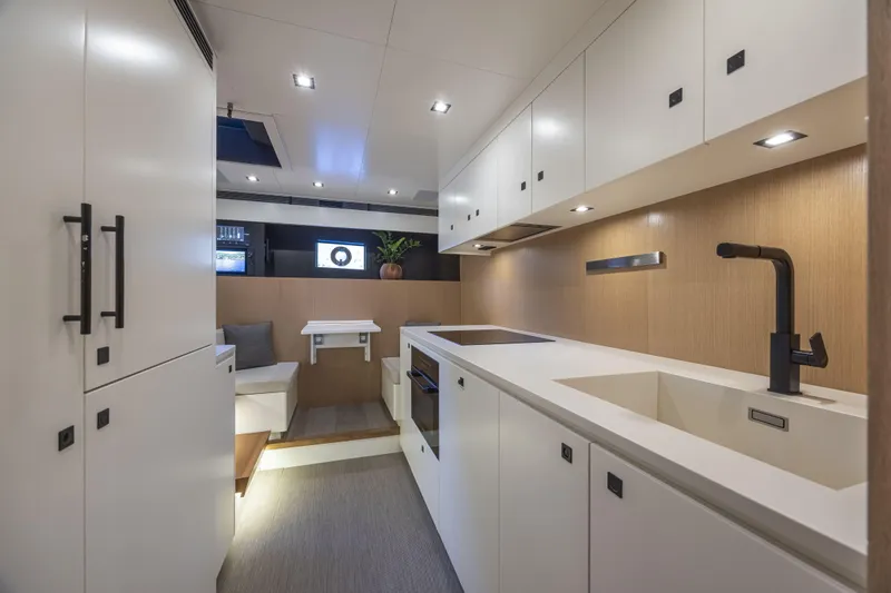  Yacht Photos Pics Luxurious interior of 2024 Otam 90 GTS yacht with modern kitchen and seating area.