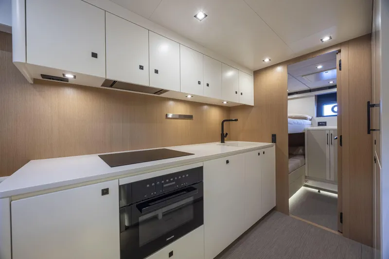  Yacht Photos Pics Luxurious interior of 2024 Otam 90 GTS yacht featuring modern kitchen design.