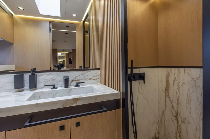  Yacht Photos Pics Luxurious bathroom interior of 2024 Otam 90 GTS yacht with marble and wood finishes.