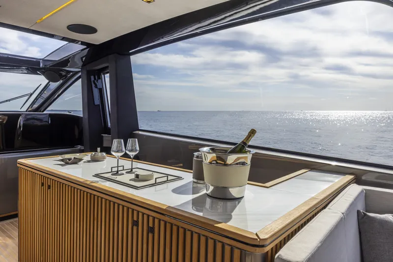  Yacht Photos Pics Luxurious interior of 2024 Otam 90 GTS yacht with ocean view and elegant dining setup.