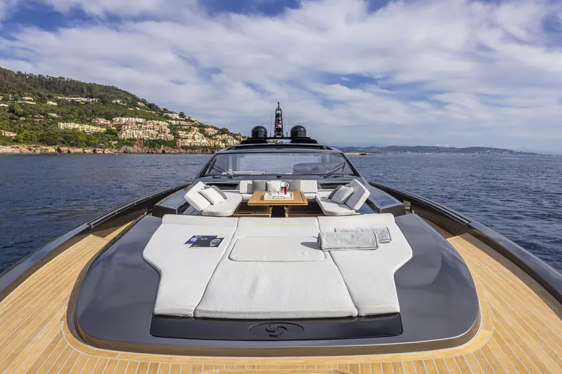  Yacht Photos Pics 2024 Otam 90 GTS luxury yacht on serene ocean with scenic coastal backdrop.