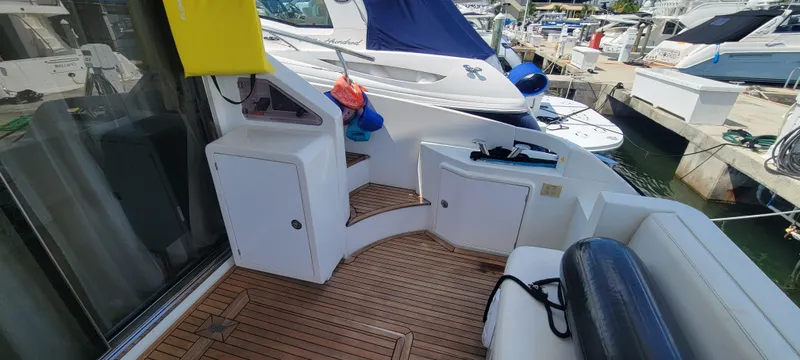  Yacht Photos Pics 2013 Azimut 45 Flybridge yacht deck with wooden flooring and storage compartments.