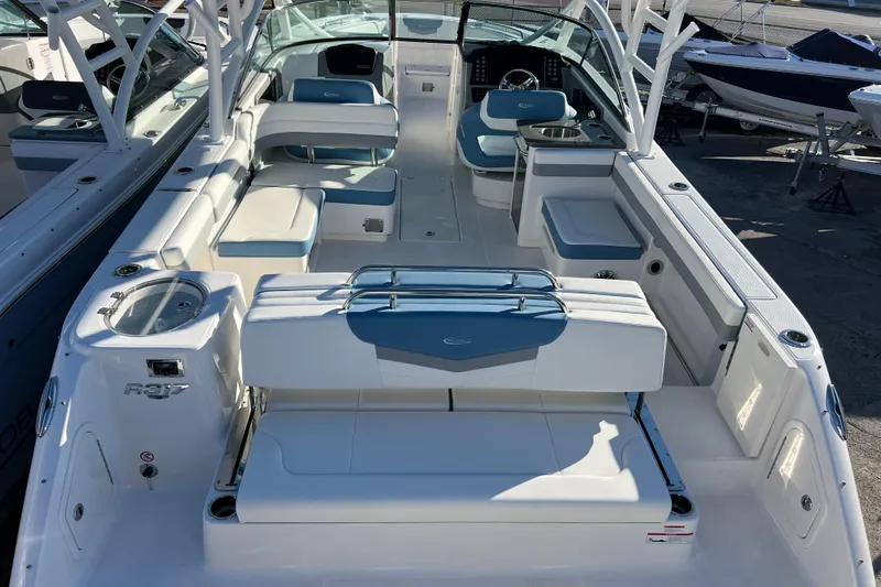  Yacht Photos Pics 2026 Robalo R317 Dual Console boat interior with seating and helm, docked outdoors.
