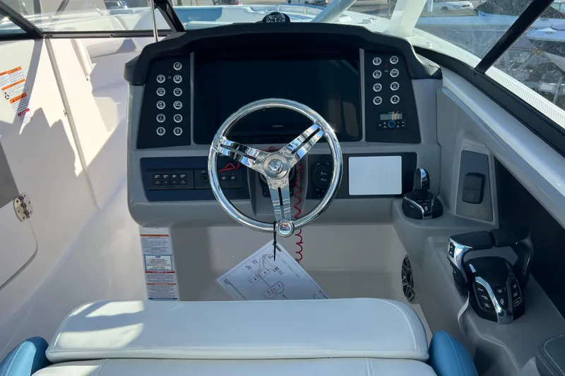 Yacht Photos Pics 2026 Robalo R317 Dual Console boat dashboard with steering wheel and controls.