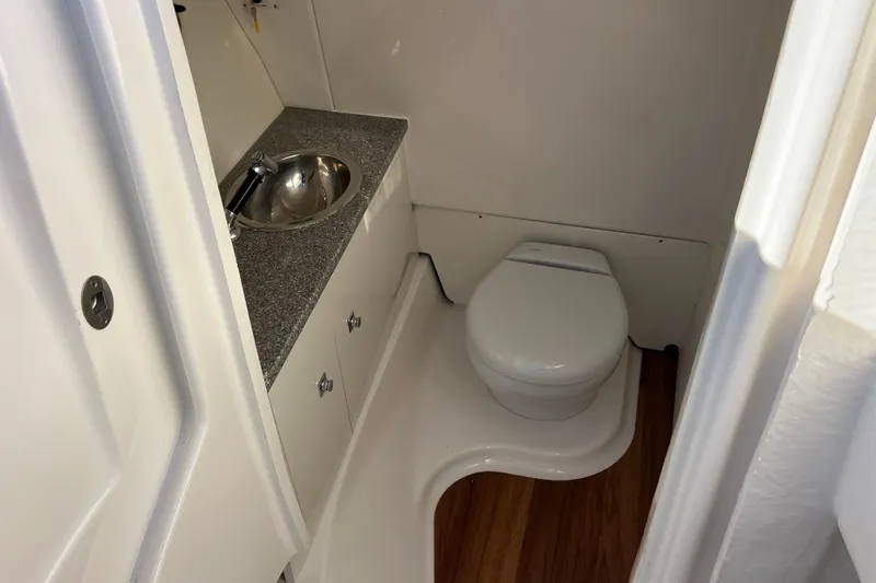  Yacht Photos Pics 2026 Robalo R317 Dual Console boat bathroom with sink and toilet.