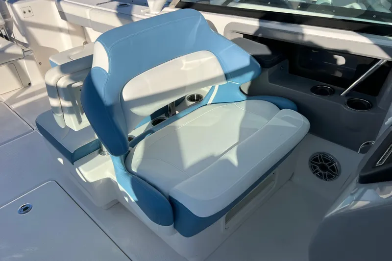  Yacht Photos Pics 2026 Robalo R317 Dual Console boat interior with blue and white seating.