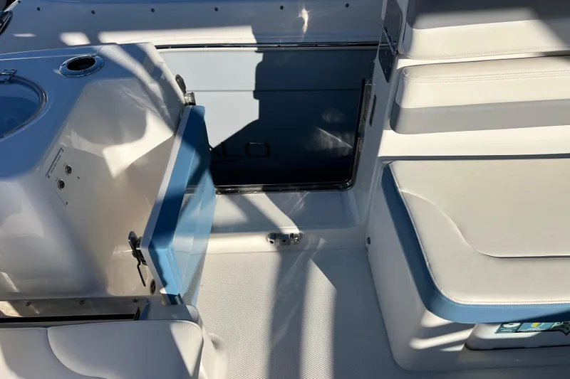  Yacht Photos Pics 2026 Robalo R317 Dual Console interior with seating and storage compartments.