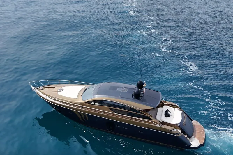 Candyman Yacht Photos Pics Luxurious 2009 Pershing 64 yacht cruising on clear blue ocean waters.