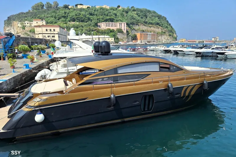 Candyman Yacht Photos Pics Luxurious 2009 Pershing 64 yacht docked in scenic marina with lush hillside backdrop.