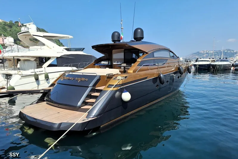 Candyman Yacht Photos Pics Luxurious 2009 Pershing 64 yacht docked in a scenic marina setting.