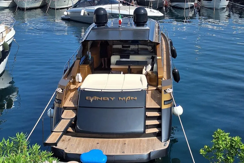 Candyman Yacht Photos Pics 2009 Pershing 64 yacht docked in marina, rear view with luxurious deck.