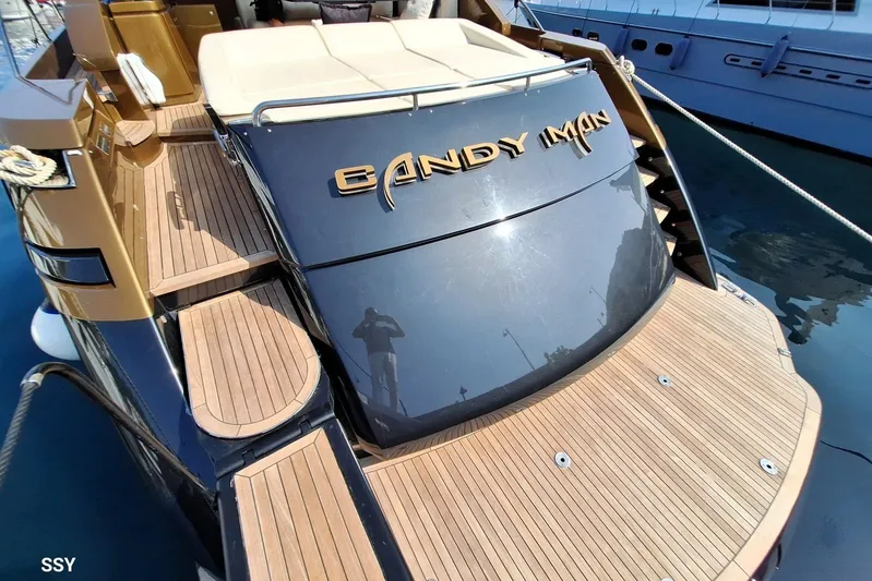 Candyman Yacht Photos Pics Luxury 2009 Pershing 64 yacht with wooden deck and sleek design, docked at marina.