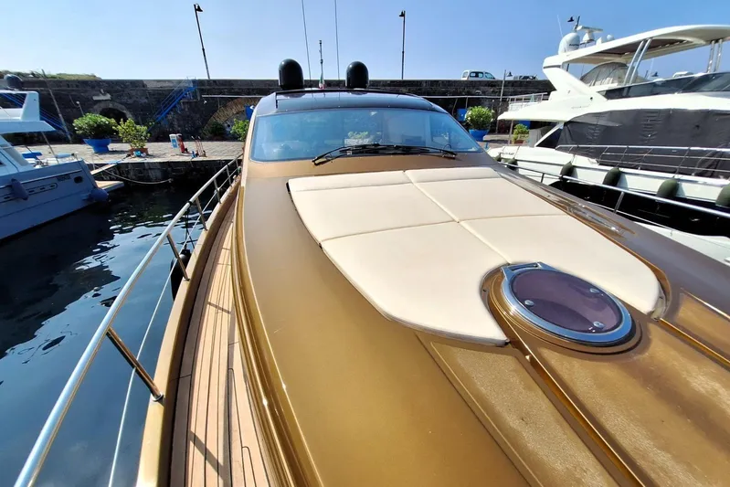 Candyman Yacht Photos Pics 2009 Pershing 64 yacht docked, featuring sleek design and sun deck, in a marina setting.