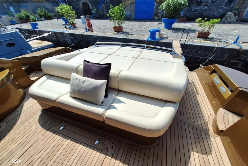 Candyman Yacht Photos Pics Luxurious 2009 Pershing 64 yacht deck with comfortable seating and cushions.