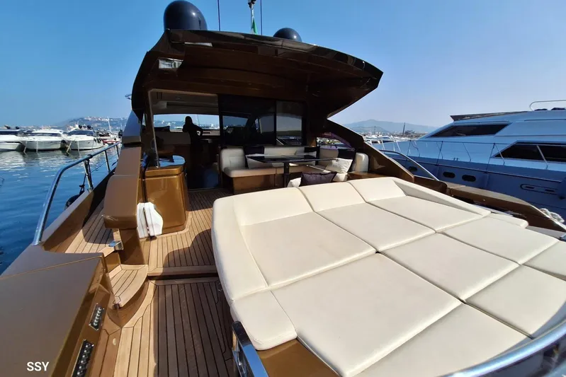 Candyman Yacht Photos Pics Luxurious 2009 Pershing 64 yacht with spacious deck and elegant seating, docked in a marina.