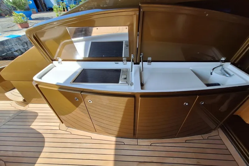 Candyman Yacht Photos Pics Outdoor kitchen on 2009 Pershing 64 yacht with sink and grill on teak deck.