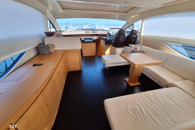 Candyman Yacht Photos Pics Luxurious interior of a 2009 Pershing 64 yacht with modern seating and helm.