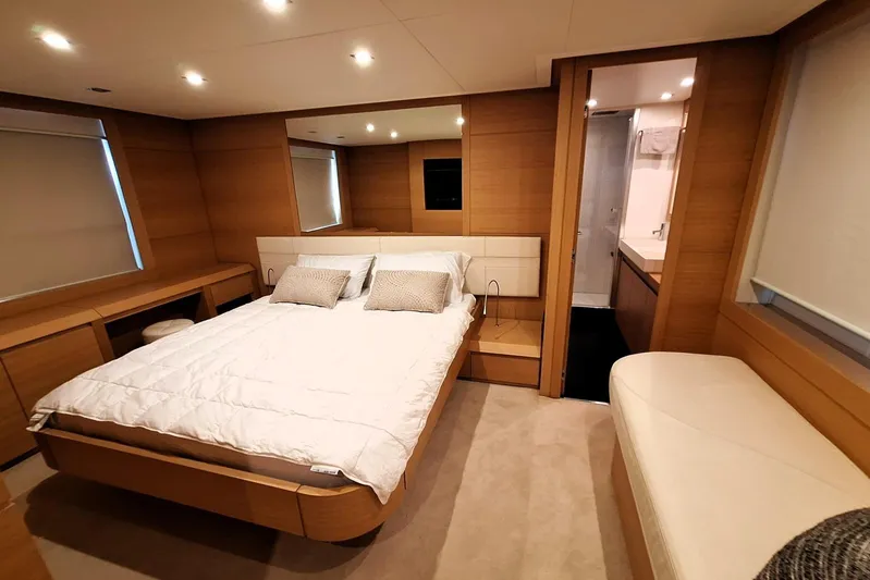 Candyman Yacht Photos Pics Luxurious bedroom interior of 2009 Pershing 64 yacht with modern design and cozy ambiance.