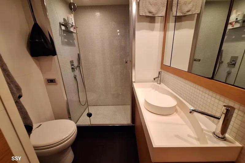 Candyman Yacht Photos Pics Luxurious bathroom in a 2009 Pershing 64 yacht, featuring modern fixtures and a glass shower.
