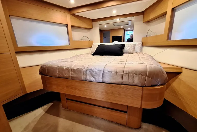 Candyman Yacht Photos Pics Luxurious bedroom interior of 2009 Pershing 64 yacht with modern wood finishes.
