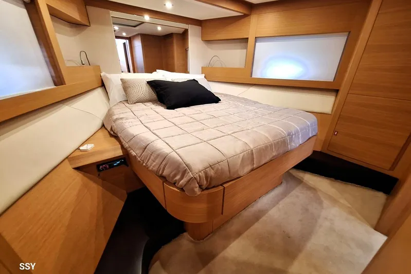 Candyman Yacht Photos Pics Luxurious bedroom interior of 2009 Pershing 64 yacht with modern wood finish.