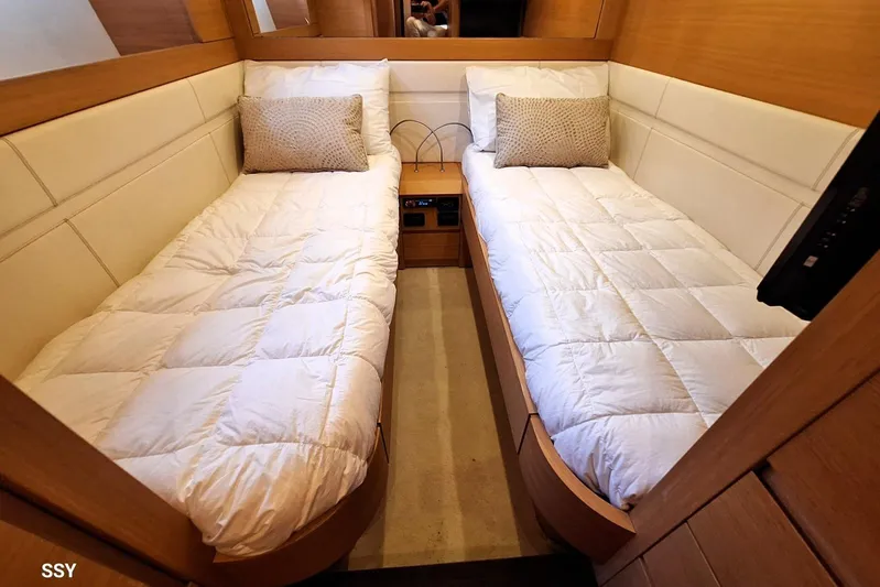 Candyman Yacht Photos Pics Luxurious twin cabin interior on a 2009 Pershing 64 yacht, featuring cozy bedding.