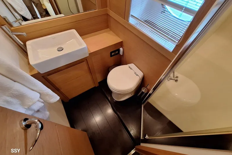 Candyman Yacht Photos Pics Luxurious bathroom in 2009 Pershing 64 yacht with modern fixtures and wooden accents.