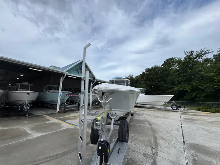  Yacht Photos Pics 2022 Fountain 38 CC boat on trailer, parked outside a storage facility.