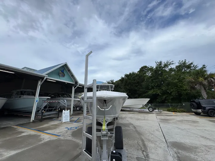  Yacht Photos Pics 2022 Fountain 38 CC boat on trailer at marina under cloudy sky.