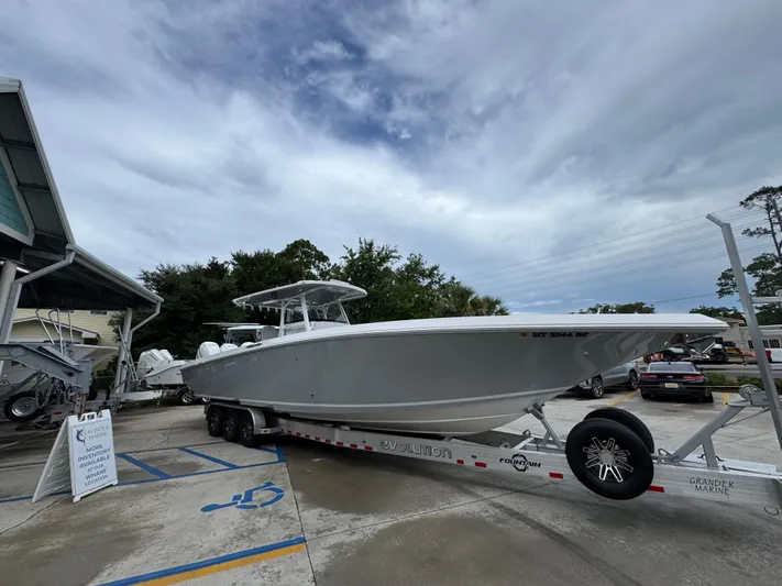  Yacht Photos Pics 2022 Fountain 38 CC boat on trailer at marina under cloudy sky.