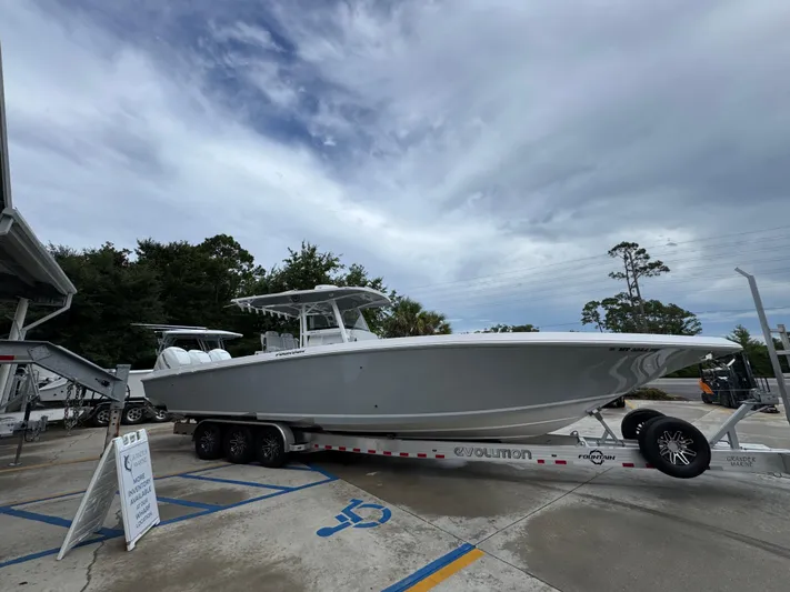 Yacht Photos Pics 2022 Fountain 38 CC boat on trailer under cloudy sky.