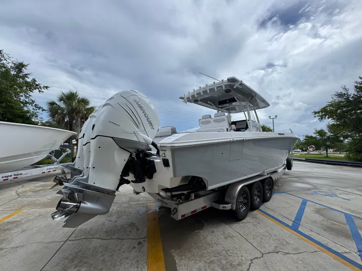  Yacht Photos Pics 2022 Fountain 38 CC boat with Mercury engines on a trailer, parked outdoors.