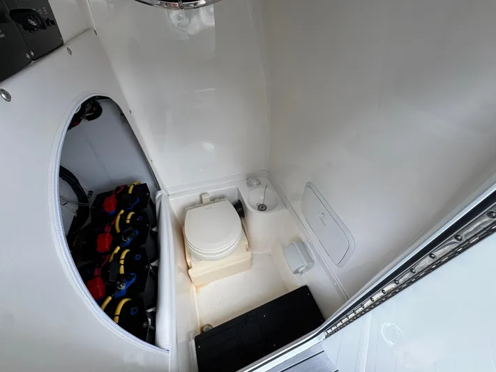 Yacht Photos Pics 2022 Fountain 38 CC boat interior with toilet and battery compartment.