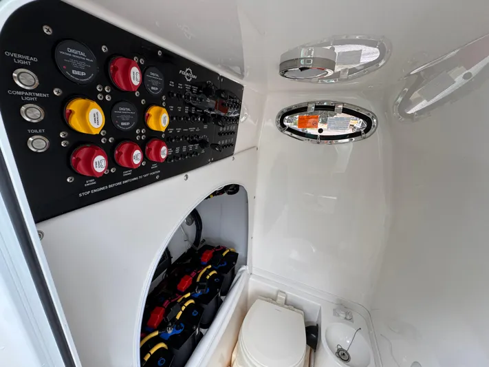 Yacht Photos Pics Control panel and toilet inside 2022 Fountain 38 CC boat cabin.
