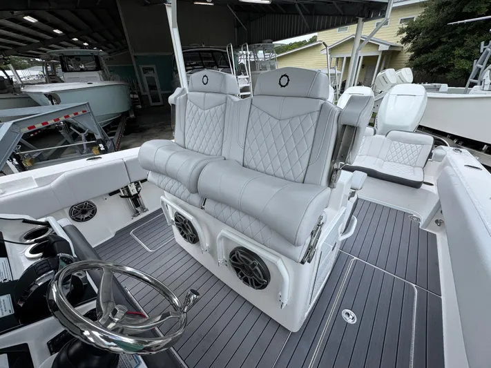  Yacht Photos Pics 2022 Fountain 38 CC boat interior with luxurious seating and modern steering wheel.