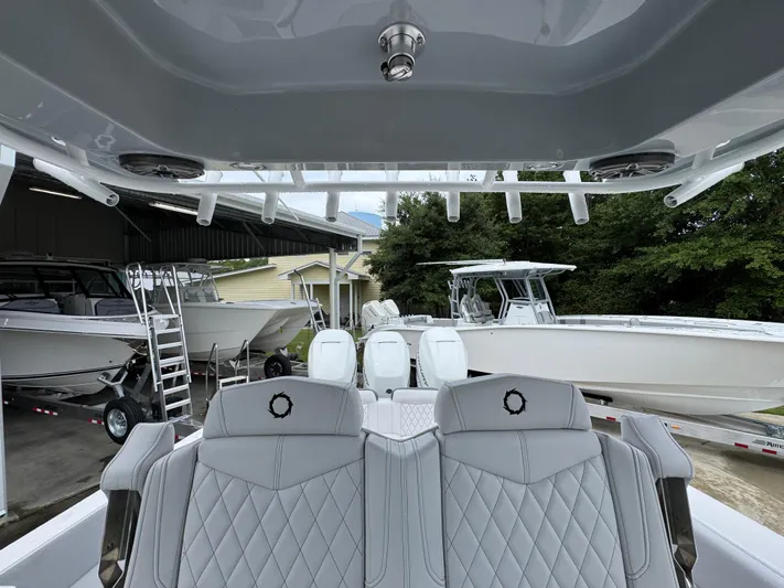  Yacht Photos Pics 2022 Fountain 38 CC boat interior with luxurious seating and multiple engines.