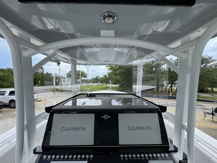  Yacht Photos Pics 2022 Fountain 38 CC boat dashboard with dual Garmin displays and control panel.