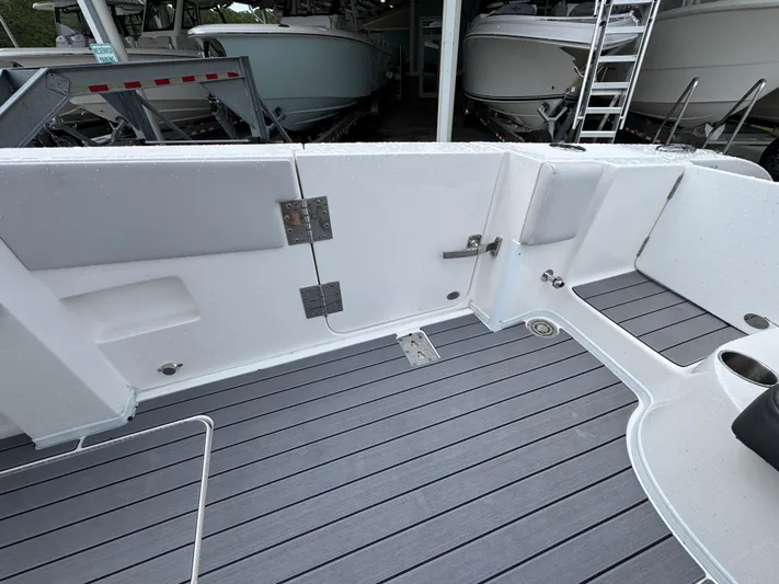  Yacht Photos Pics 2022 Fountain 38 CC boat deck with sleek, modern design and gray flooring.