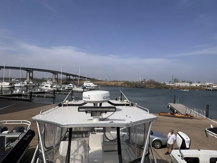  Yacht Photos Pics 1998 Contender 35 Express Side Console at marina with bridge and waterfront view.