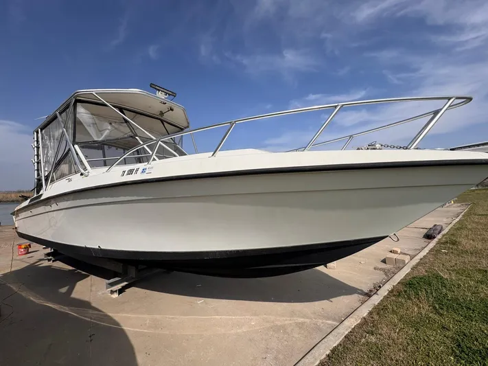  Yacht Photos Pics 1998 Contender 35 Express Side Console boat on a concrete dock under a clear sky.