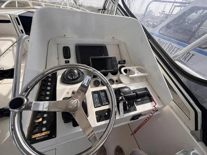  Yacht Photos Pics 1998 Contender 35 Express Side Console helm with steering wheel, controls, and navigation equipment.
