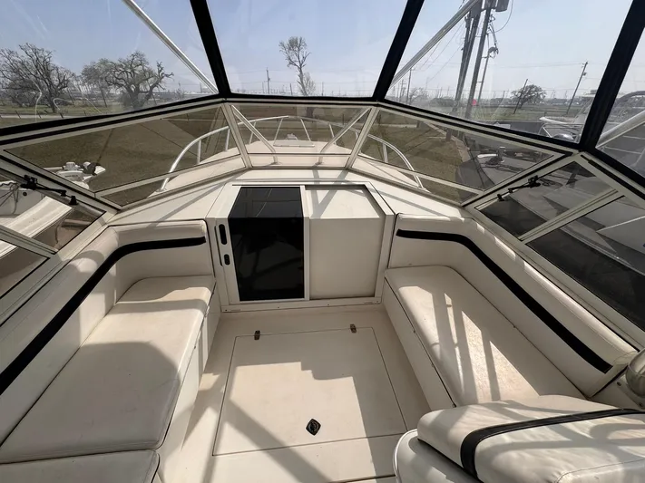  Yacht Photos Pics 1998 Contender 35 Express Side Console interior with white seating and panoramic windows.