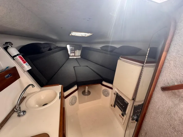  Yacht Photos Pics 1998 Contender 35 Express Side Console cabin with sink, seating, and storage.