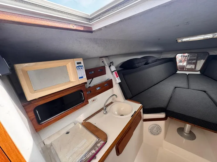 Yacht Photos Pics Interior of 1998 Contender 35 Express Side Console with kitchenette and seating area.