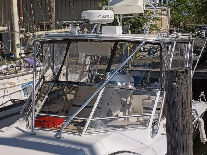  Yacht Photos Pics 1998 Contender 35 Express Side Console boat with Garmin radar, docked in marina.