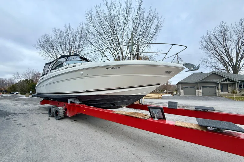  Yacht Photos Pics 2004 Searay 360 Sundancer boat on red trailer, parked on a residential street.