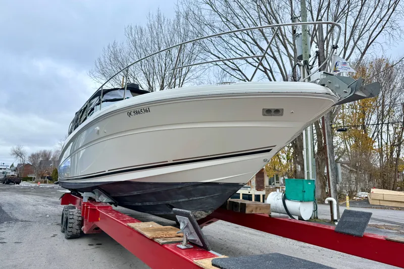  Yacht Photos Pics 2004 Searay 360 Sundancer boat on trailer, parked outdoors, overcast sky.