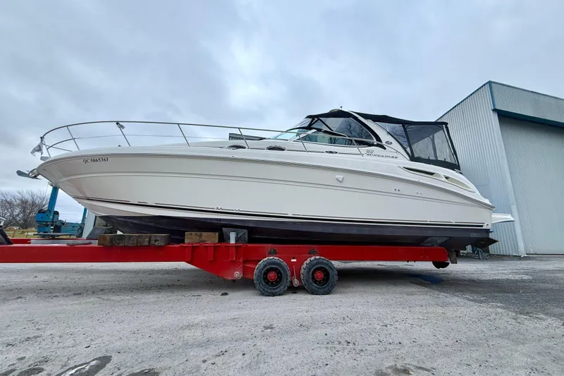  Yacht Photos Pics 2004 Searay 360 Sundancer boat on red trailer, parked outdoors.