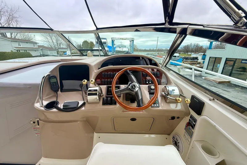  Yacht Photos Pics Helm of 2004 Searay 360 Sundancer with wooden steering wheel and control panel.